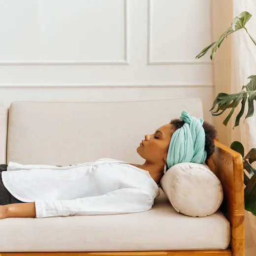 A client resting quietly on a couch after a session